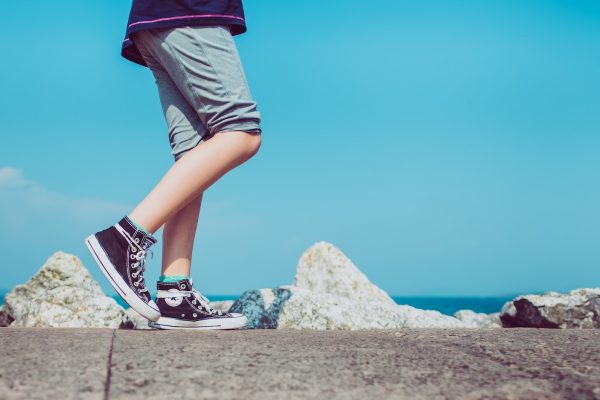 person walking on gray concrete pavement